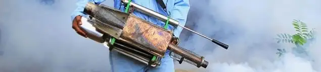 Fumigation technician using a fogger for deep pest treatment in Duluth, MN